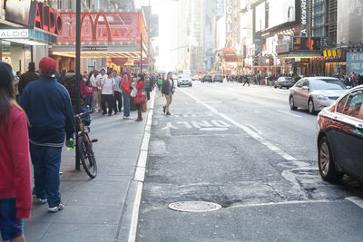 Crowd on sidewalk in city