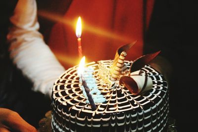 Close-up of hand holding cake