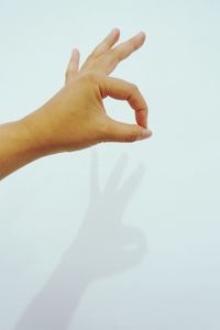 Shadow of hand on white background