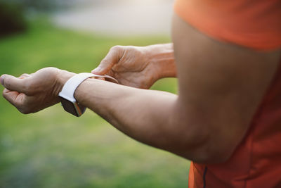 Close-up of man wearing smart watch