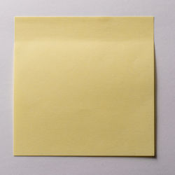 Directly above shot of yellow paper against wall