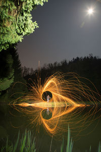 Light painting on tree against sky at night