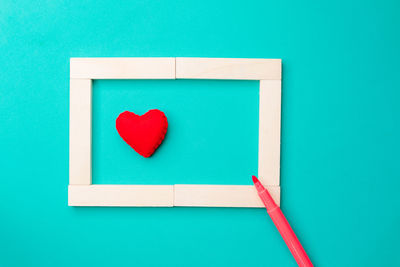 Directly above shot of heart shape on blue wall