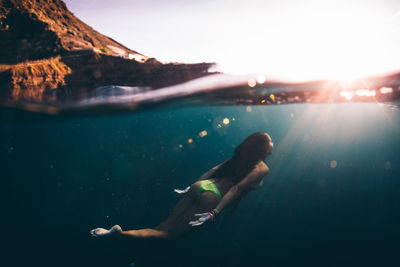 Full length of woman swimming in sea at canary islands