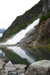 Idyllic view of waterfall against sky