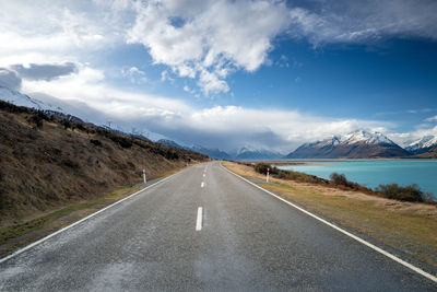 Mount cook road alongside lake pukaki with snow capped southern alps in winter evening light. 