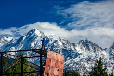 Scenic view of snowcapped mountains against blue sky