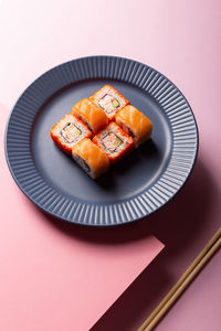 Traditional japanese food philadelphia sushi on a modern pink background, minimalistic concept