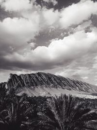 Scenic view of mountains against cloudy sky