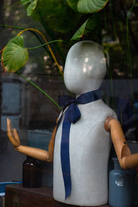 Close-up of mannequin on glass