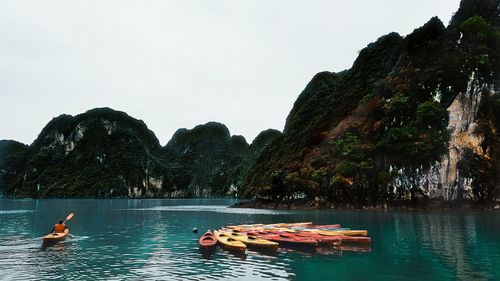 Scenic view of boats in lake against sky