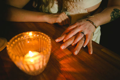 Close-up of woman hand on illuminated table