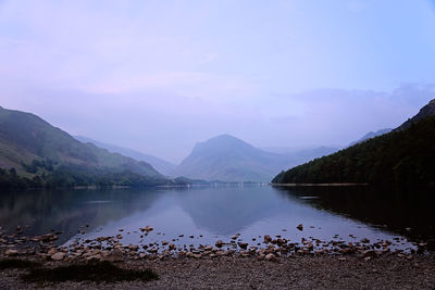 Scenic view of lake and mountains against sky