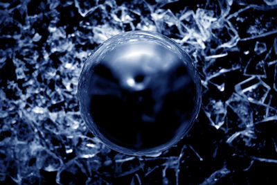 High angle view of crystal ball on water