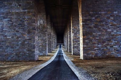 Bridge amidst brick wall