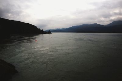 View of beach against cloudy sky