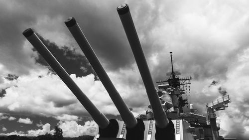 Low angle view of battleship against cloudy sky