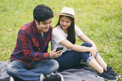 Full length of young man using mobile phone