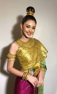 Portrait of young woman standing against white background