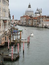 Boats in canal by buildings in city, grand canal, venice