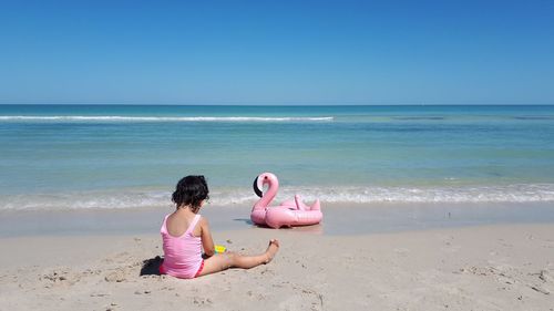 Boy on beach against sky