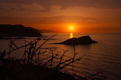 Scenic view of sea against romantic sky at sunset