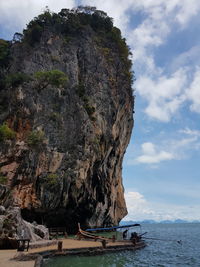 Scenic view of rock formation by sea against sky