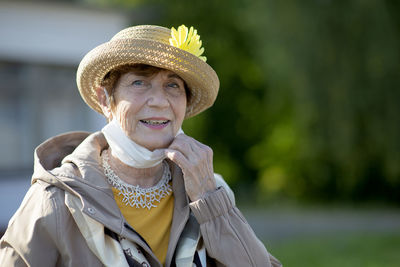 Portrait of positive senior woman  with face mask,  lifestyle of elderly people in autumn holiday