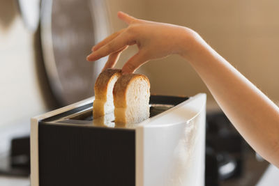 Cropped hand of woman holding cake