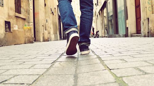 Low section of man walking on footpath