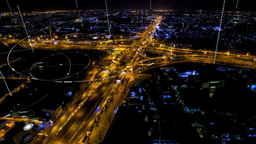 High angle view of light trails on road in city at night