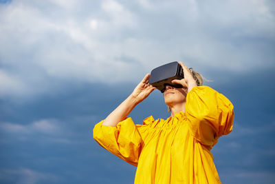 Low angle view of woman wearing vr glasses