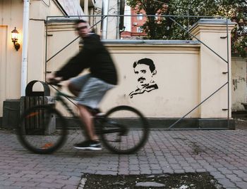 Man cycling on bicycle in city