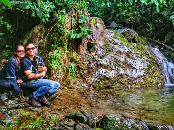 Portrait of man sitting on rock