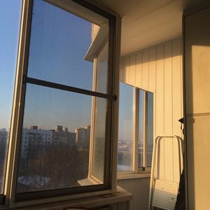 Buildings against sky seen through glass window