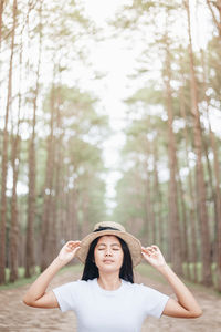 Portrait of beautiful young woman in forest