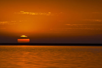 Scenic view of sea against romantic sky at sunset