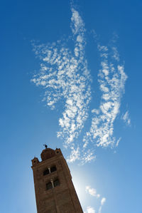 Low angle view of cross on building against sky