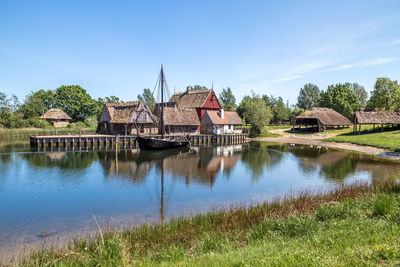 Scenic view of lake and buildings against sky