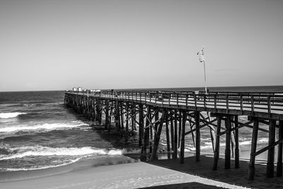 Pier over sea against clear sky