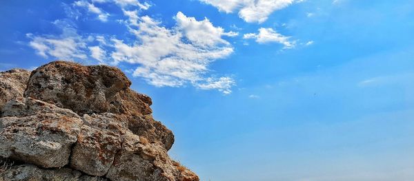 Low angle view of rock formation against sky