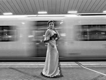 Full length of woman standing on train at railroad station