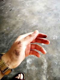 High angle view of cropped hand against blurred background