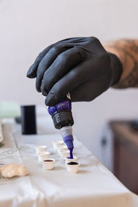 Cropped hand of man holding dentures