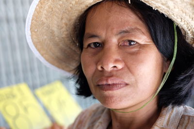 Close-up portrait of woman wearing hat