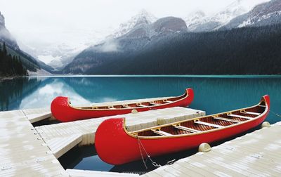 Canoes moored at lakeshore during winter