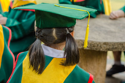 Rear view of woman in graduation gown