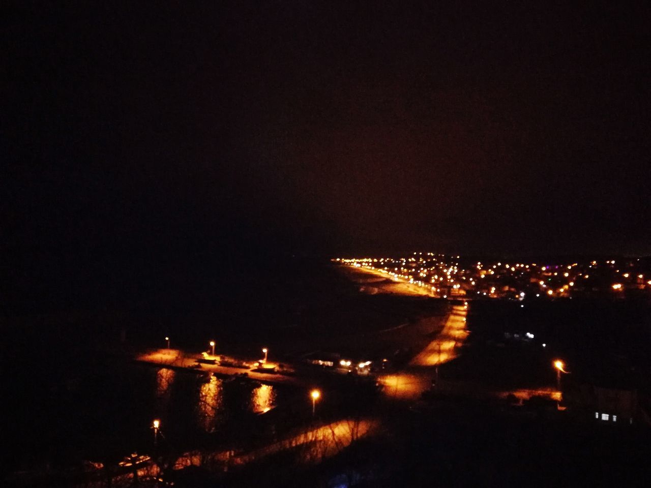 HIGH ANGLE VIEW OF ILLUMINATED BUILDINGS AGAINST SKY