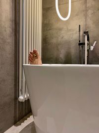 Low section of man relaxing in bathroom