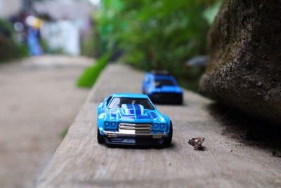 Blue toy cars on wood